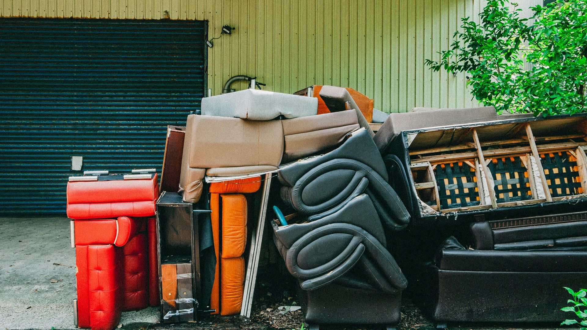 A pile of trash sitting in front of a garage